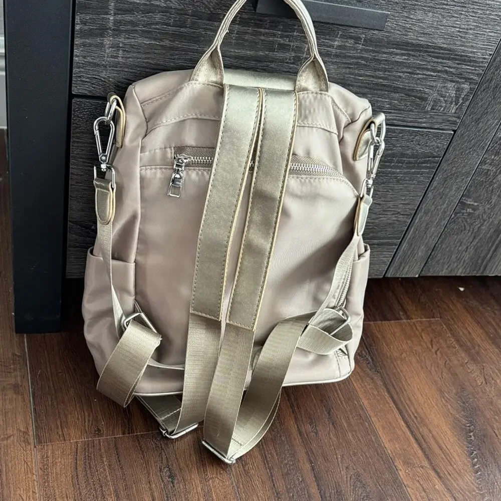 Neutral Taupe Woman’s Backpack with Metallic Accent and many zipper pockets. - Picture 2 of 13